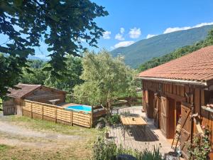 a house with a swimming pool next to a building at Le Refuge De L'Ourse in Anla