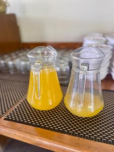 two containers of orange juice sitting on a table at Hunza Embassy Hotel by Zeez in Karimabad Hunza +68 photos