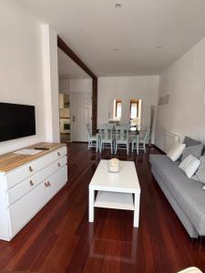 a living room with a couch and a table at Apartamento Arena in Ribadesella