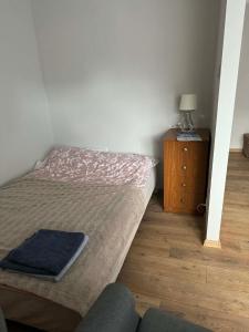 a small bedroom with a bed and a night stand at Wygodny kąt in Tarnobrzeg +12 photos