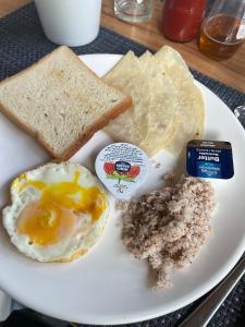 a plate of breakfast food with eggs bread and toast at Zukara Maldives in Thoddoo