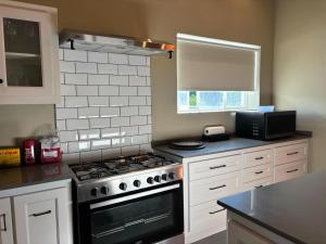 a kitchen with a stove and a microwave at River and Ridge in Cradock