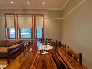 a living room with a wooden table and a couch at River and Ridge in Cradock +13 photos