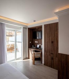 a bedroom with a bed and a desk with a chair at The Republic Boutique Hotel in Valletta