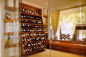 a room filled with lots of bottles of wine at Hotel Spa Nau Royal in Camburi
