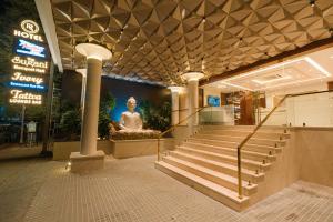 a staircase in a building with a statue in it at Royal Ritis in Shimoga