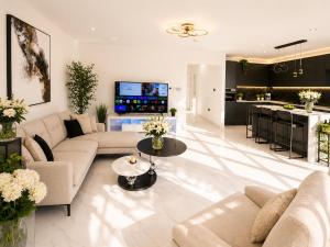 a living room with a couch and a table at Luxurious & Elegant 6-Bed House in Barnet
