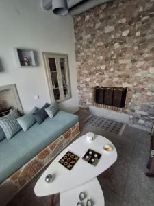 a living room with a couch and a fireplace at Traditional house in the heart of Naxos in Dhamariónas