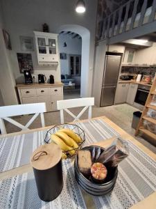 a table with a basket of bananas and bread on it at Traditional house in the heart of Naxos in Dhamariónas