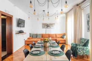 a living room with a table and a couch at Apartments Dare & Piccolo in Kaštela