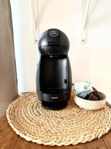 a black coffee maker sitting on top of a table at appartement mauléon in Mauléon