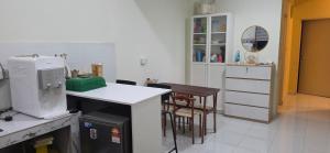 a kitchen with a counter and a table and chairs at Rumah Inap Nik Atik in Cukai