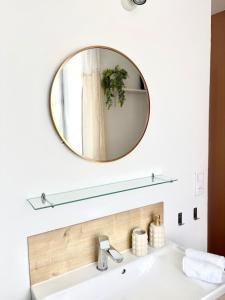 a bathroom with a mirror above a sink at appartement mauléon in Mauléon +12 photos