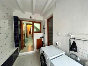 a kitchen with a washing machine in a room at Casa De Pueblo Raval in Teulada +47 photos