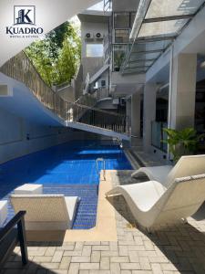 a swimming pool in the middle of a building at Kuadro Hotel & Suites in Moalboal