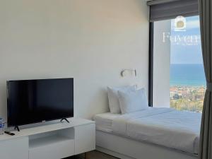 a bedroom with a bed and a flat screen tv at Nook Inn - Apec Phu Yen in Tuy Hoa