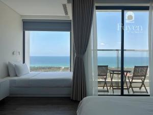 a bedroom with a bed and a view of the ocean at Nook Inn - Apec Phu Yen in Tuy Hoa