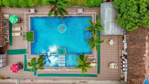 an overhead view of a swimming pool with palm trees at Bardibas Resort in Tulsi