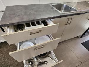 a kitchen with a counter with drawers and a sink at RotoVegas Motel of Rotorua in Rotorua +60 photos