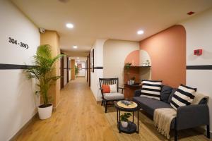 a living room with a couch and a table at Olive Hotel JP Nagar Metro by Embassy Group in Bangalore