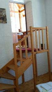 a wooden staircase in a room with a window at Hank O'brat in Lovech