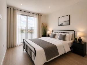 a bedroom with a large bed and a large window at Luxurious & Elegant 6-Bed House in Barnet