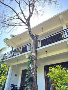 a house with a tree in front of it at Ella Heaven View in Ella