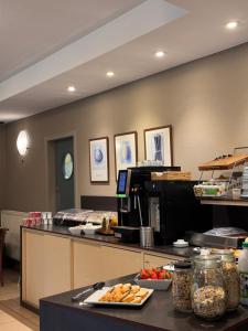 a kitchen with a counter with food on it at Hobbit Hotel Brussels Airport Zaventem in Zaventem