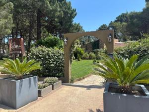 an entrance to a garden with two potted plants at Kilina in Porto-Vecchio