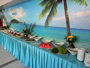 ein Buffet mit Speisen und ein Wandgemälde des Meeres in der Unterkunft Belsea Hotel in Beldibi