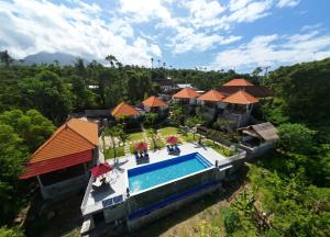 an aerial view of a resort with a swimming pool at Gistari Inn & Restaurant in Seraya