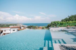 a large swimming pool with a view of the ocean at Azanti Residence in Ulcinj