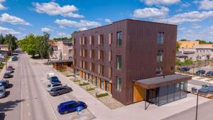 a building on a street with cars parked in a parking lot at New apartment in Karlova in Tartu
