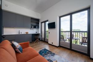 a living room with a couch and a kitchen at New apartment in Karlova in Tartu