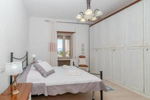 a bedroom with a bed and a table with a lamp at De Addis Guest House in Aggius