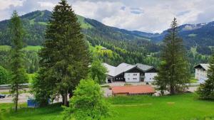 a group of houses in a field with trees at Alex in Balderschwang