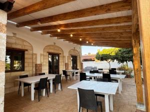 an outdoor patio with tables and chairs and tablesearcher at A casa di Raf in Torre Lapillo