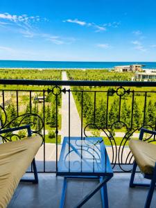 a balcony with chairs and a view of the ocean at Panorama in Sumqayıt