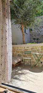 a bench and a table next to a tree at Huma Living in Vlorë