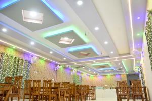 a room with chairs and lights on the ceiling at S S Plaza in mayapur