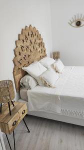 a bedroom with a large bed and a chair at LA MAISON DE MARIE A 8 mn des plages in Perpignan +27 photos