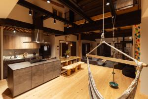 a kitchen with a hammock in the middle of a room at ひのまきbase-暖- in Uda +116 photos