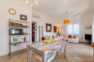 a living room with a table and chairs at Villa Oleandro - 2349447 in San Teodoro