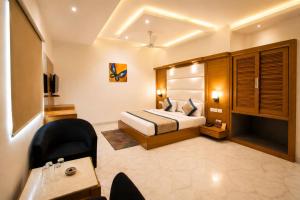a hotel room with a bed and a desk at Hotel Aero Star by Star Group in New Delhi