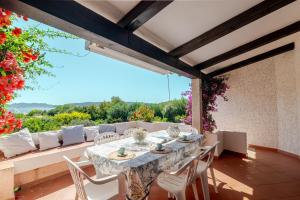 a dining room with a table and chairs on a patio at Trilocale Taverna 80 mt spiaggia in Porto Taverna