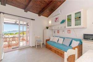 a bedroom with a blue bed and a balcony at Trilocale Taverna 80 mt spiaggia in Porto Taverna