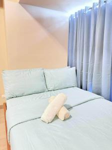 a stuffed animal sitting on top of a bed at The Mactan Newtown in Punta Engaño