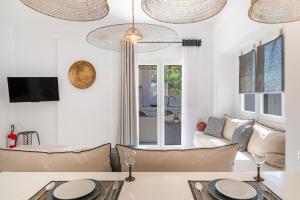 a living room with a couch and a table at Edem Garden Suite in Andros