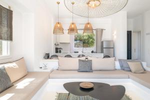 a living room with a couch and a table at Edem Garden Suite in Andros