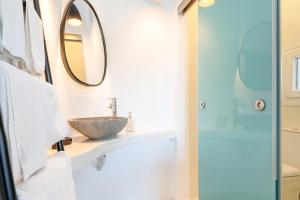 a bathroom with a sink and a mirror at Edem Garden Suite in Andros +15 photos